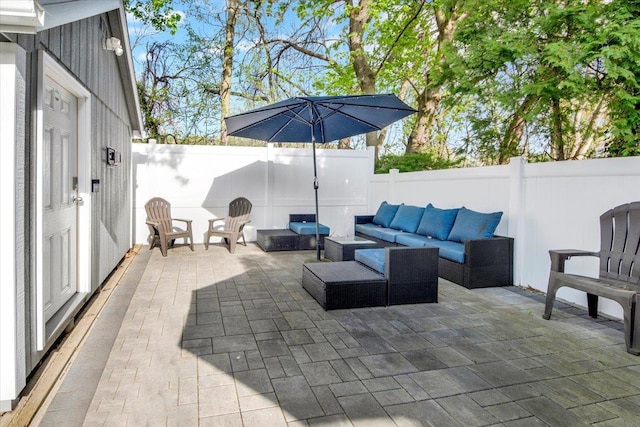 view of patio featuring a fenced backyard and an outdoor living space