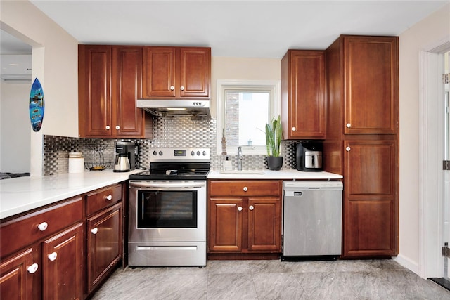 71 E Kissimee Rd, Lindenhurst, NY 11757 - kitchen with under cabinet range hood, stainless steel appliances, light countertops, and a sink