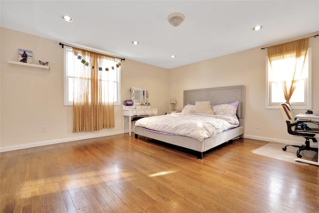 71 E Kissimee Rd, Lindenhurst, NY 11757 - bedroom featuring baseboards, wood finished floors, recessed lighting, and multiple windows