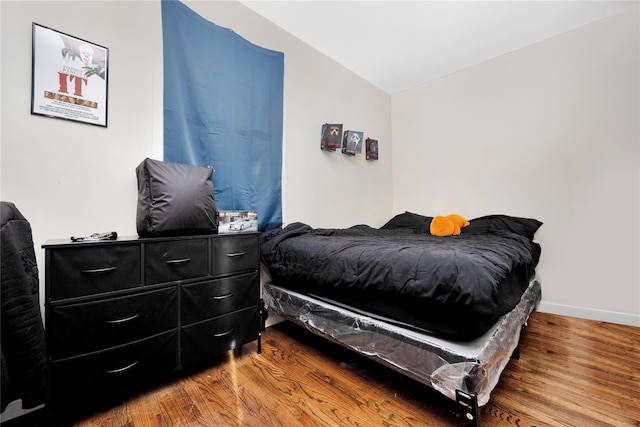 71 E Kissimee Rd, Lindenhurst, NY 11757 - bedroom with vaulted ceiling, baseboards, and wood finished floors