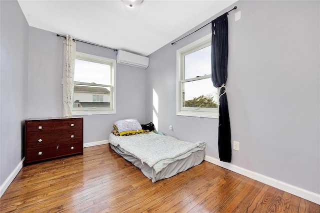 71 E Kissimee Rd, Lindenhurst, NY 11757 - bedroom with wood-type flooring, a wall mounted air conditioner, and baseboards
