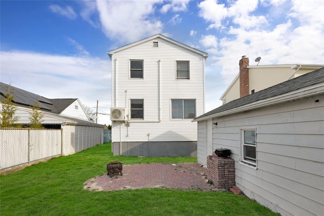 71 E Kissimee Rd, Lindenhurst, NY 11757 - rear view of property featuring fence, a yard, a patio, and an outdoor fire pit