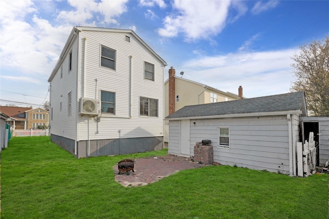 71 E Kissimee Rd, Lindenhurst, NY 11757 - back of house with a lawn, ac unit, an outdoor fire pit, and fence