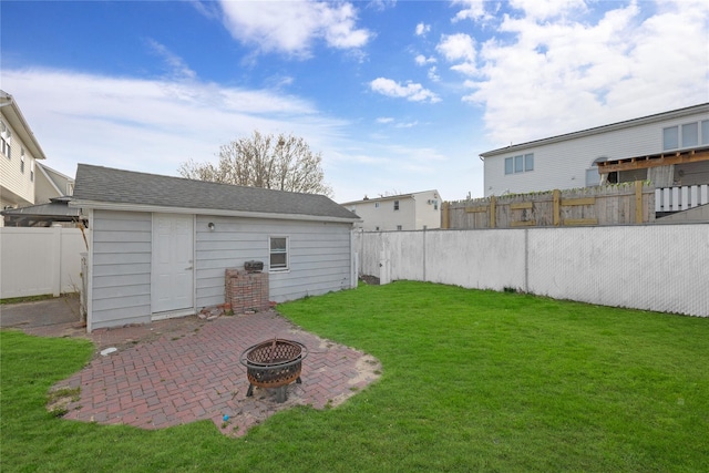 71 E Kissimee Rd, Lindenhurst, NY 11757 - view of yard featuring a fenced backyard, an outbuilding, a patio area, and an outdoor fire pit
