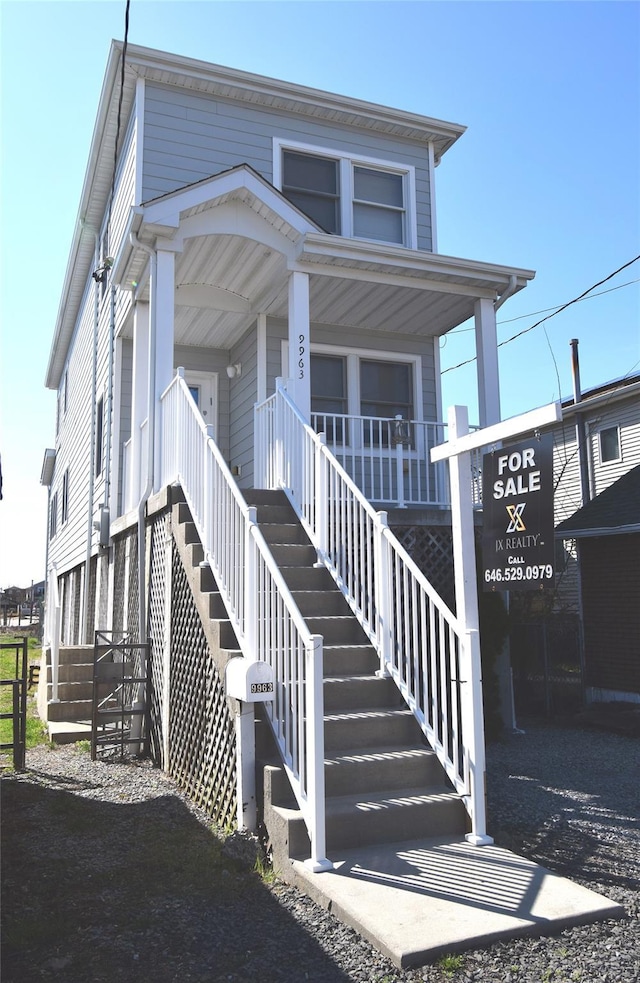 exterior space with stairs and covered porch