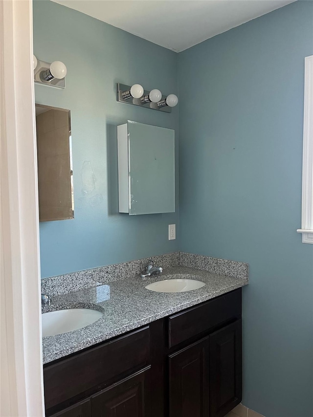 bathroom featuring double vanity and a sink