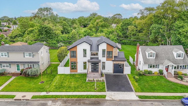296 Division Ave, Hicksville, NY 11801 - view of front of house featuring a balcony, a garage, asphalt driveway, and a standing seam roof