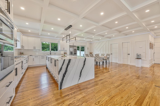 296 Division Ave, Hicksville, NY 11801 - kitchen featuring light wood finished floors, coffered ceiling, a large island, white cabinets, and stainless steel fridge with ice dispenser