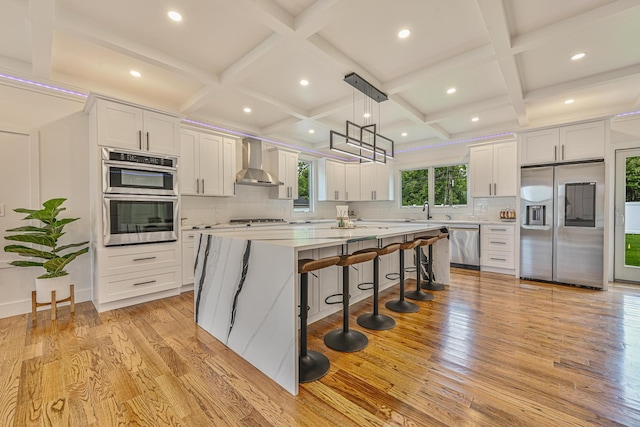 296 Division Ave, Hicksville, NY 11801 - kitchen with stainless steel appliances, wall chimney exhaust hood, coffered ceiling, a center island, and tasteful backsplash