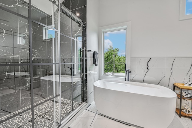 296 Division Ave, Hicksville, NY 11801 - bathroom with marble finish floors, a freestanding tub, a marble finish shower, and tile walls
