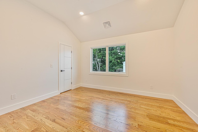 296 Division Ave, Hicksville, NY 11801 - spare room featuring lofted ceiling, light wood finished floors, and baseboards