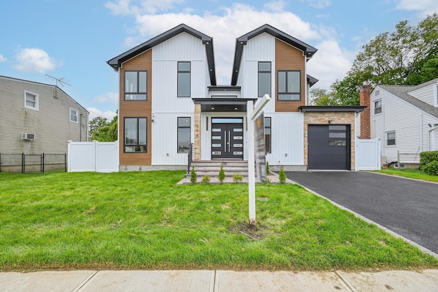 296 Division Ave, Hicksville, NY 11801 - contemporary home with asphalt driveway, stone siding, and board and batten siding