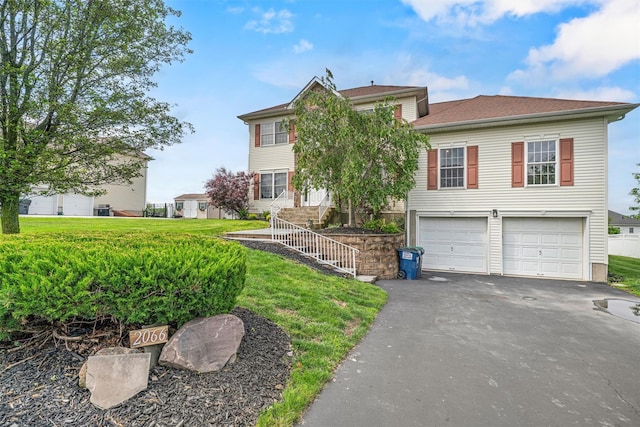 2066 Independence Dr, New Windsor, NY 12553 - view of front of property with asphalt driveway, a garage, and a front lawn