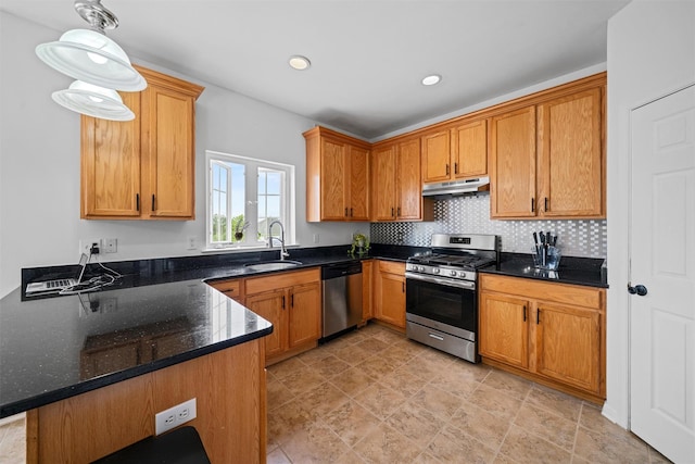 2066 Independence Dr, New Windsor, NY 12553 - kitchen with appliances with stainless steel finishes, under cabinet range hood, dark stone counters, recessed lighting, and hanging light fixtures