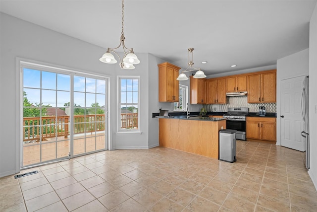 2066 Independence Dr, New Windsor, NY 12553 - kitchen featuring appliances with stainless steel finishes, under cabinet range hood, a peninsula, dark countertops, and decorative backsplash
