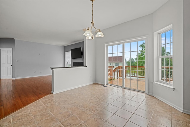2066 Independence Dr, New Windsor, NY 12553 - unfurnished room featuring baseboards and a chandelier