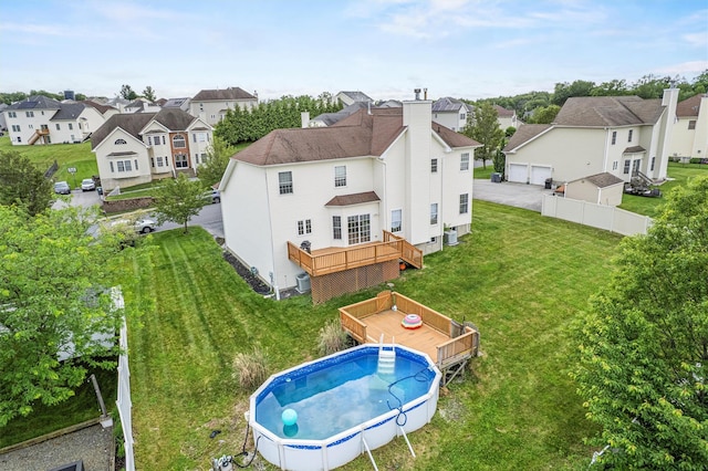 2066 Independence Dr, New Windsor, NY 12553 - rear view of property with a wooden deck, a residential view, an outdoor pool, a yard, and a detached garage