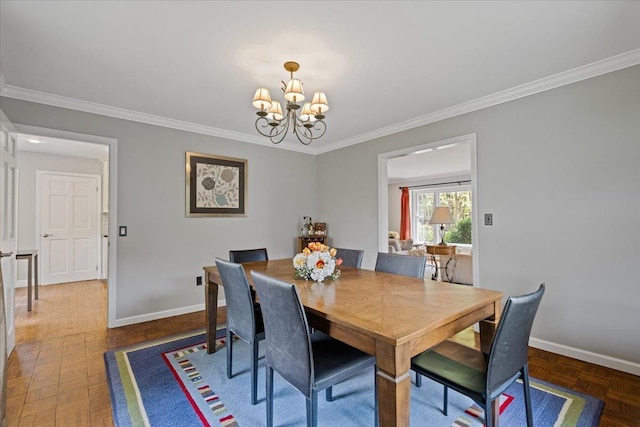 dining space featuring an inviting chandelier, baseboards, and crown molding