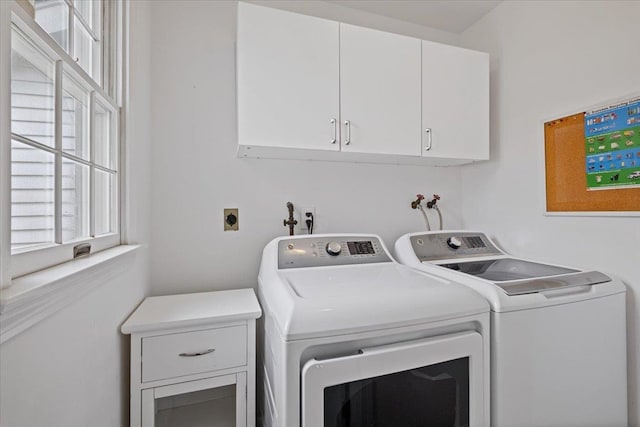laundry area with washing machine and dryer and cabinet space