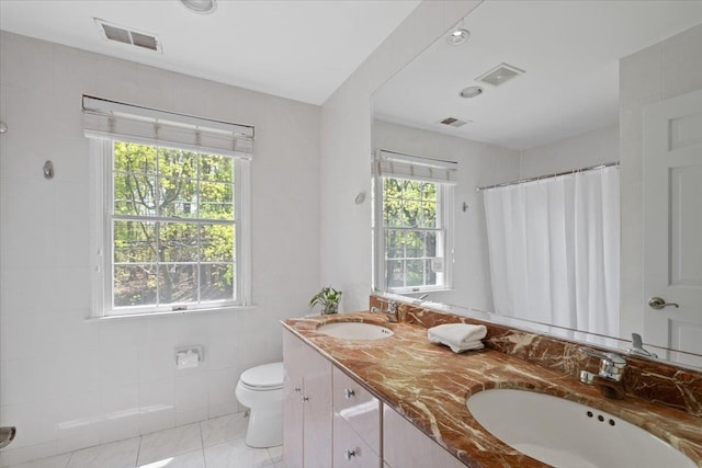 bathroom featuring a sink, tile patterned floors, toilet, and visible vents