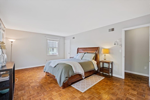 bedroom featuring baseboards and visible vents