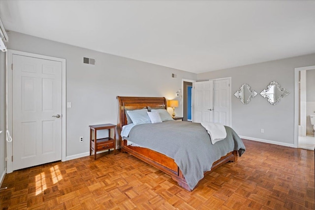 bedroom with baseboards and visible vents
