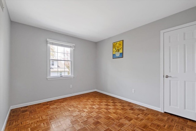 spare room featuring baseboards