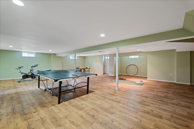 rec room featuring baseboards, plenty of natural light, and wood finished floors