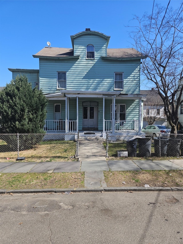 view of front of house with fence private yard and covered porch