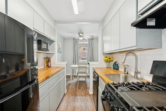 153-25 88th St Unit 1F, Howard Beach, NY 11414 - kitchen featuring ceiling fan, backsplash, black appliances, butcher block counters, and under cabinet range hood