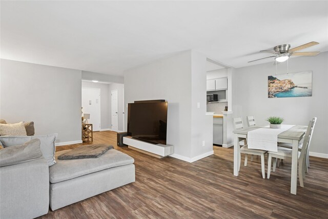 153-25 88th St Unit 1F, Howard Beach, NY 11414 - living room with dark wood-type flooring, baseboards, and ceiling fan