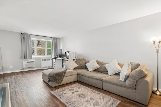 153-25 88th St Unit 1F, Howard Beach, NY 11414 - living room featuring wood finished floors, a wall mounted air conditioner, baseboards, and radiator heating unit