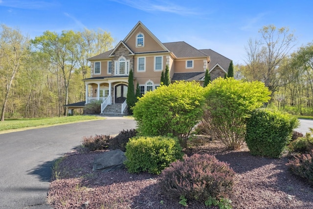 view of front of property featuring covered porch and stucco siding