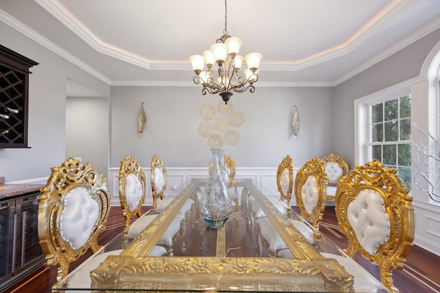 dining room featuring crown molding, a notable chandelier, and a decorative wall