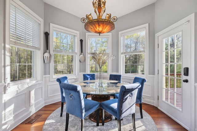 sunroom / solarium with a chandelier and visible vents