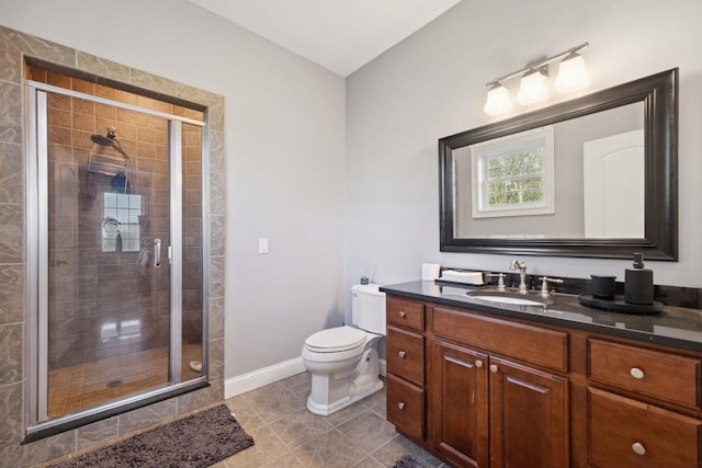 bathroom with vanity, baseboards, a shower stall, and toilet
