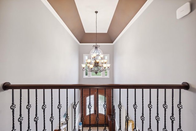 interior space with ornamental molding, vaulted ceiling, and a chandelier