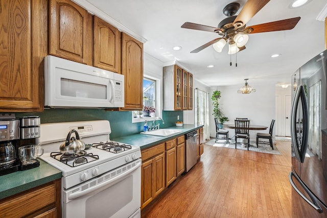 24 Linda Ln, East Moriches, NY 11940 - kitchen featuring brown cabinetry, white appliances, a sink, and ceiling fan