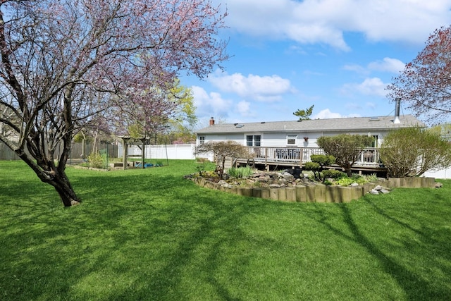 24 Linda Ln, East Moriches, NY 11940 - rear view of property featuring a wooden deck, a yard, a chimney, and fence