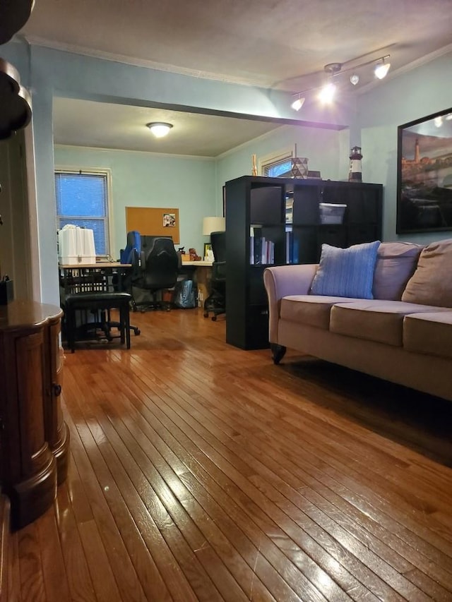 living area featuring ornamental molding and hardwood / wood-style flooring
