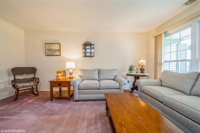 carpeted living room with visible vents and baseboards