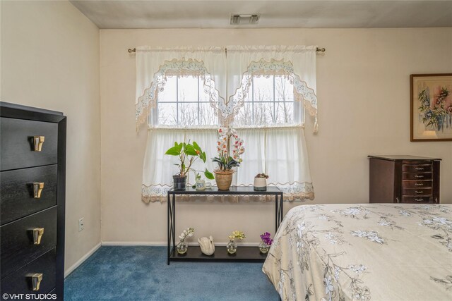 carpeted bedroom featuring visible vents, baseboards, and multiple windows