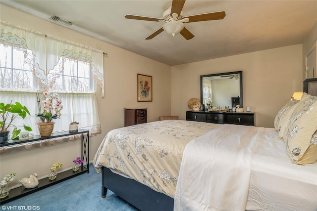 bedroom with a ceiling fan, visible vents, and carpet