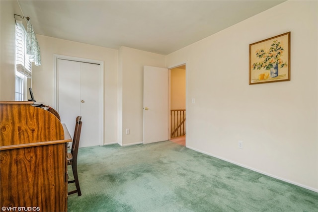 unfurnished office with baseboards and carpet flooring