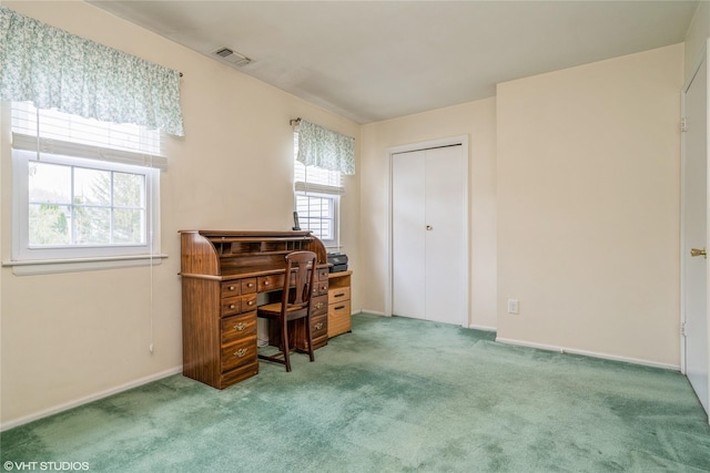 carpeted office space featuring visible vents and baseboards