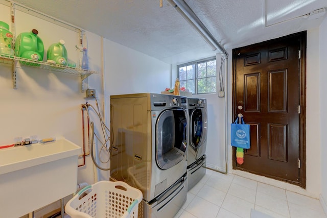 67-54 Groton St, Forest Hills, NY 11375 - clothes washing area with a textured ceiling, a sink, light tile patterned flooring, washer and dryer, and laundry area