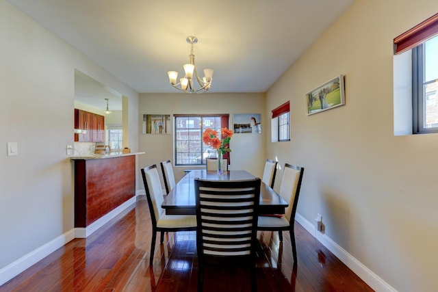 67-54 Groton St, Forest Hills, NY 11375 - dining area featuring an inviting chandelier, dark wood-style floors, and baseboards