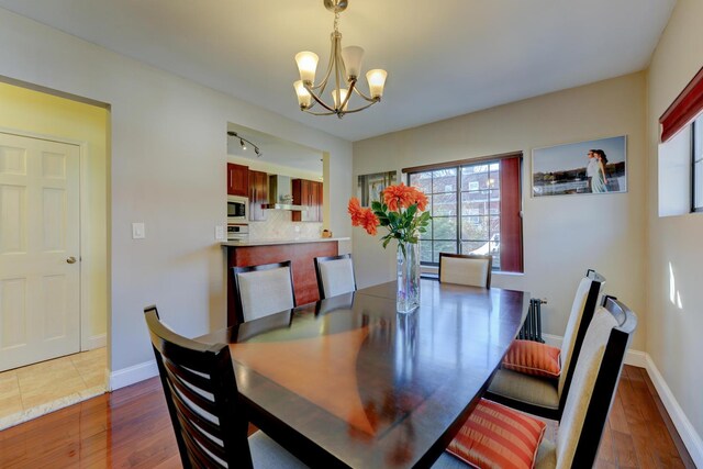 67-54 Groton St, Forest Hills, NY 11375 - dining area featuring baseboards, a notable chandelier, and dark wood finished floors