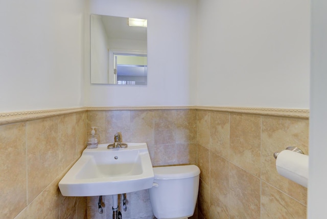 67-54 Groton St, Forest Hills, NY 11375 - half bathroom with wainscoting, tile walls, a sink, and toilet