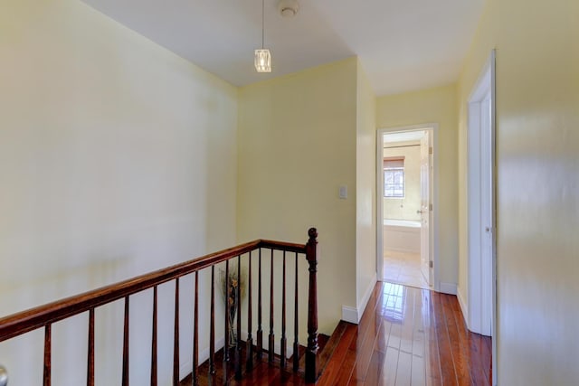 67-54 Groton St, Forest Hills, NY 11375 - hallway with baseboards, hardwood / wood-style flooring, and an upstairs landing